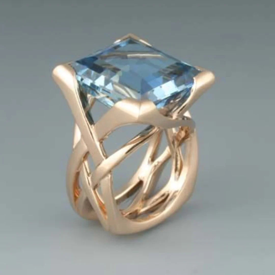 Bague vintage en or rose et zircone bleue